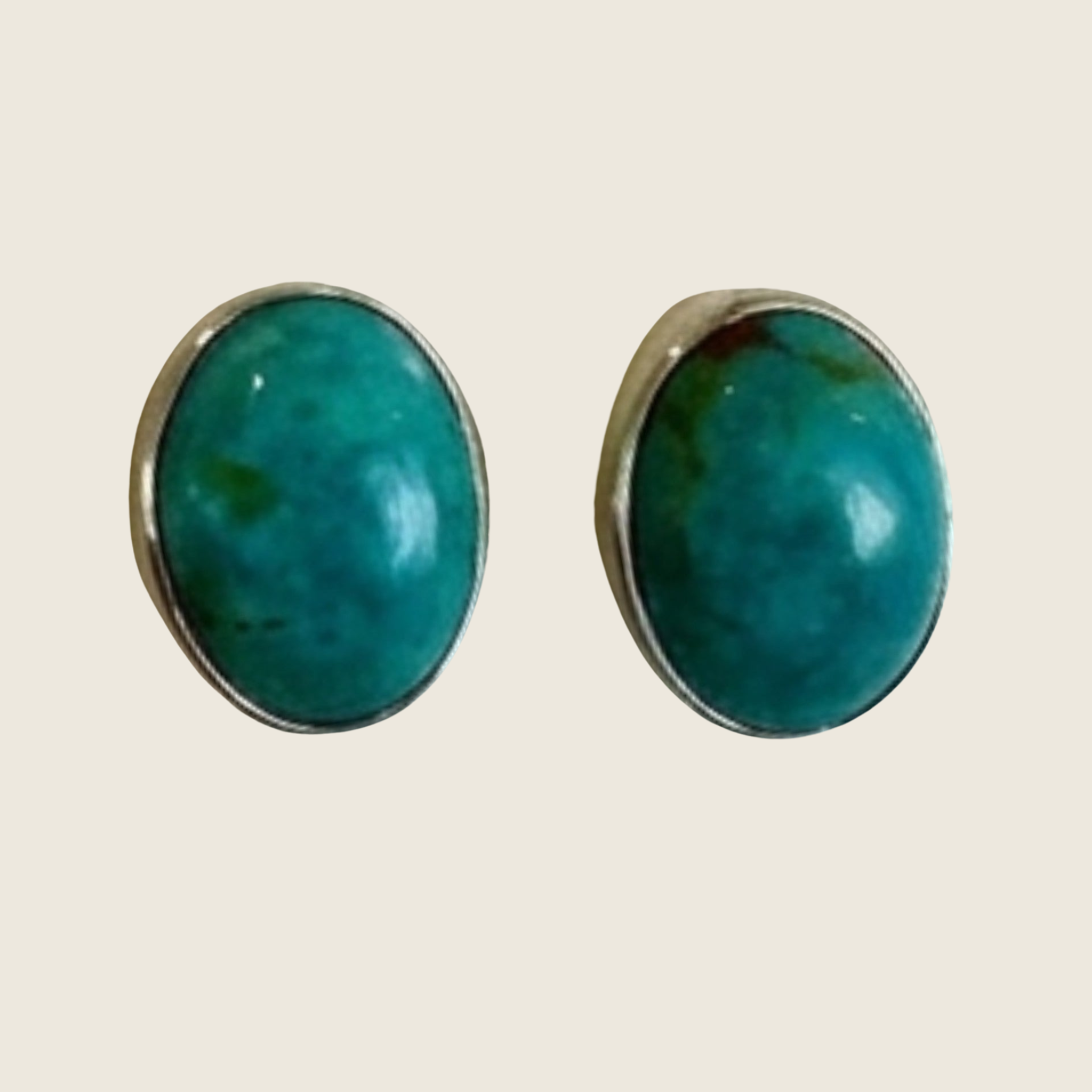 Turquoise oval stud earrings in sterling silver, one of a kind, shown on a bone linen background