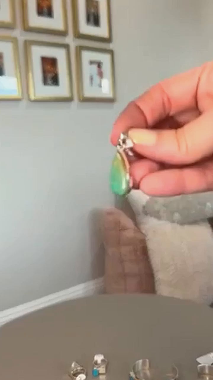 Royston turquoise teardrop pendant in sterling silver, held in hand