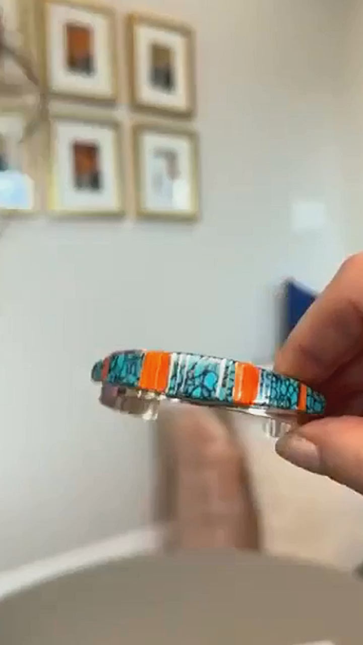 Turquoise and spiny oyster channel inlay cuff in sterling silver, shown in hand and on the wrist