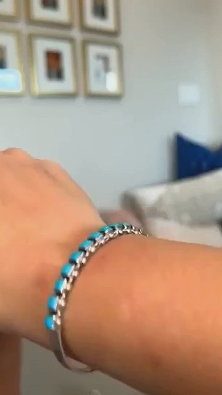 Sleeping Beauty turquoise row bangle in sterling silver, worn on the wrist