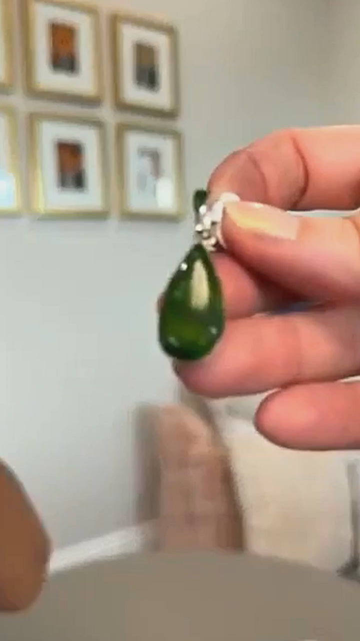 Sonoran Mountain turquoise teardrop pendant in sterling silver, held in hand