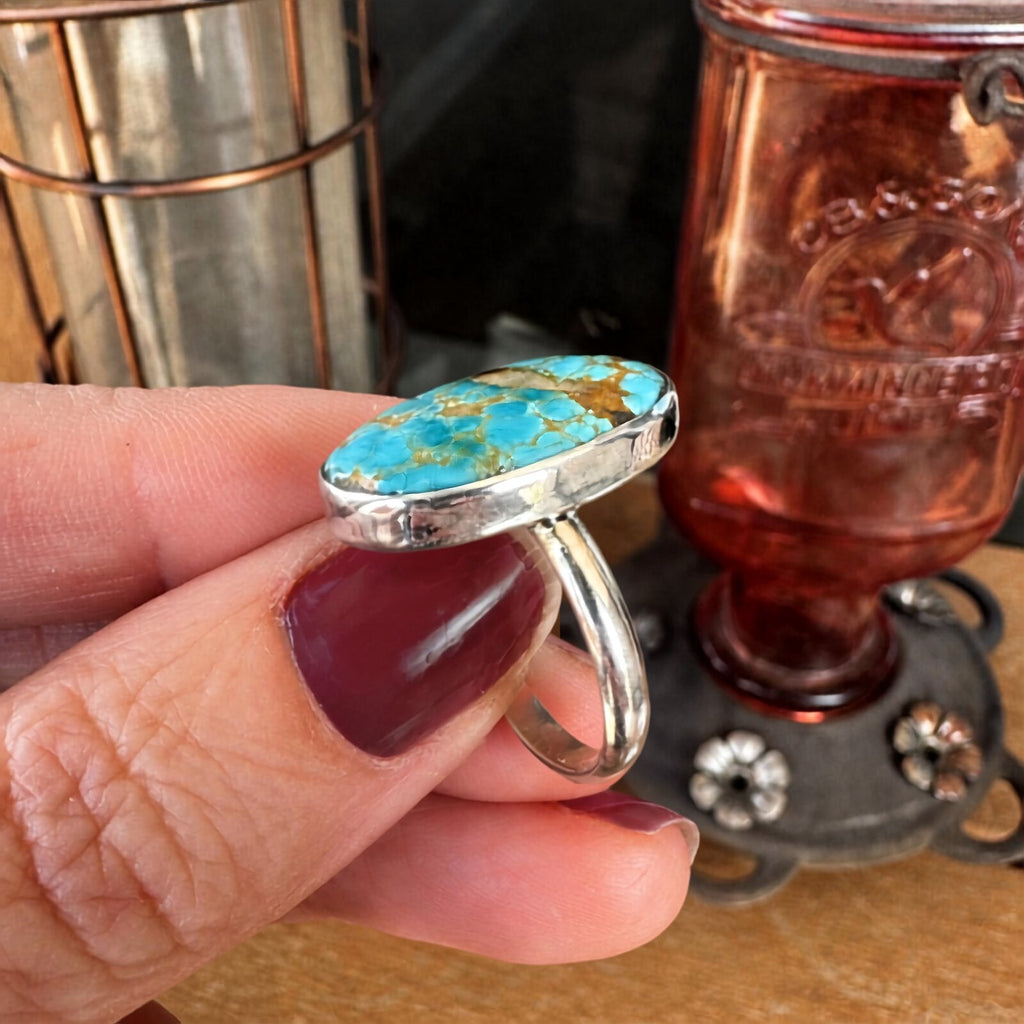 Side profile of the Royston turquoise ring showing the sterling silver bezel setting and band