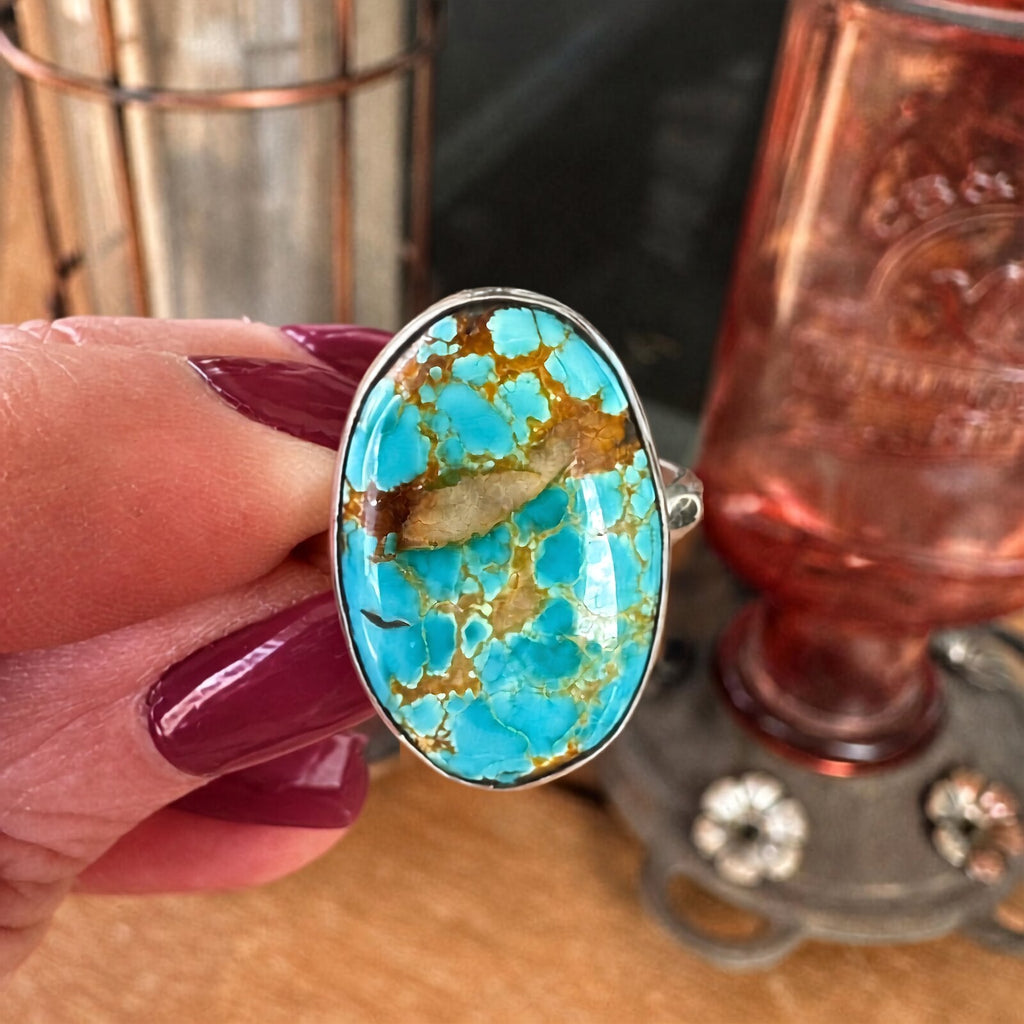 Royston turquoise sterling silver ring held in hand, showing the scale of the 11 carat oval stone