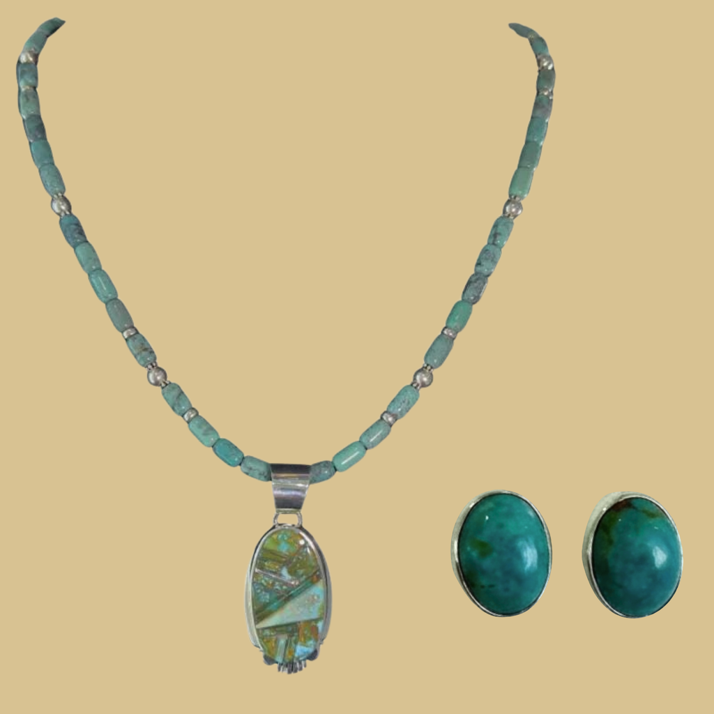 Green turquoise pendant and oval turquoise stud earrings jewelry set in sterling silver, shown on a warm sand background