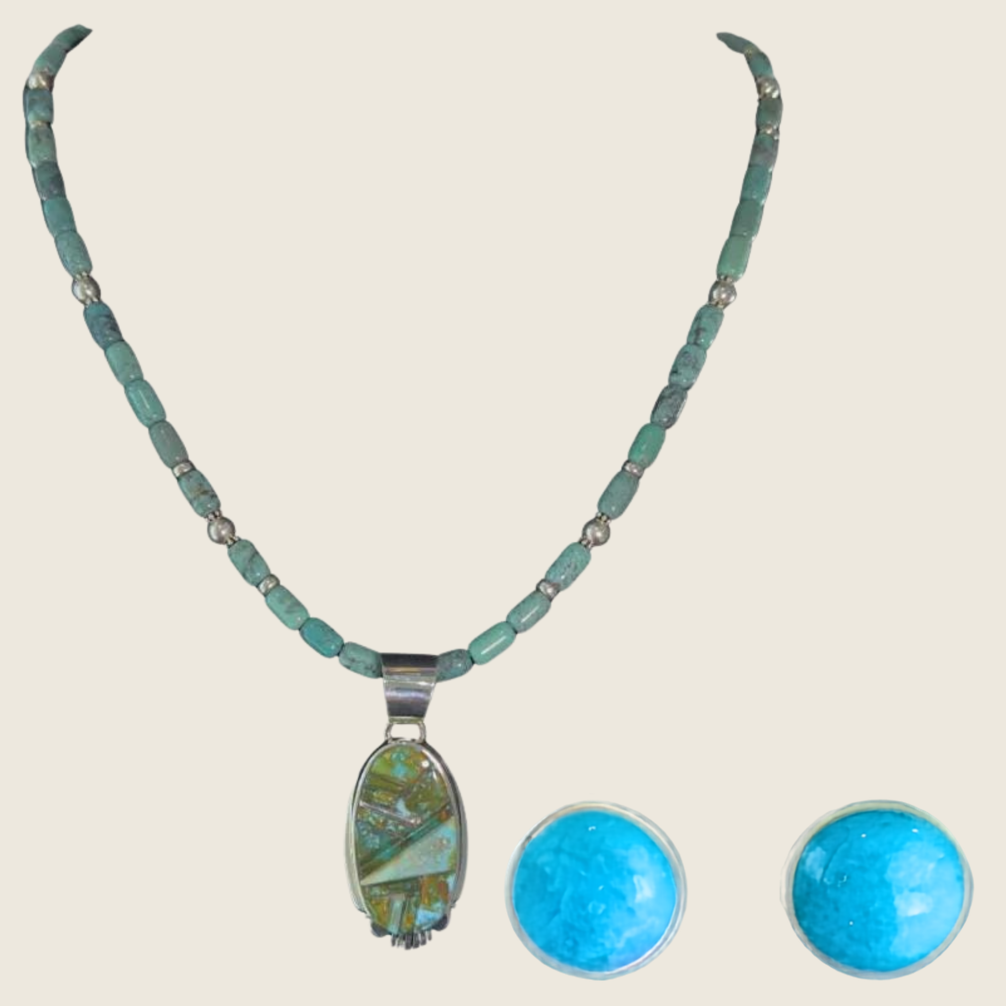 Green turquoise pendant and turquoise stud earrings jewelry set in sterling silver, shown on a bone linen background