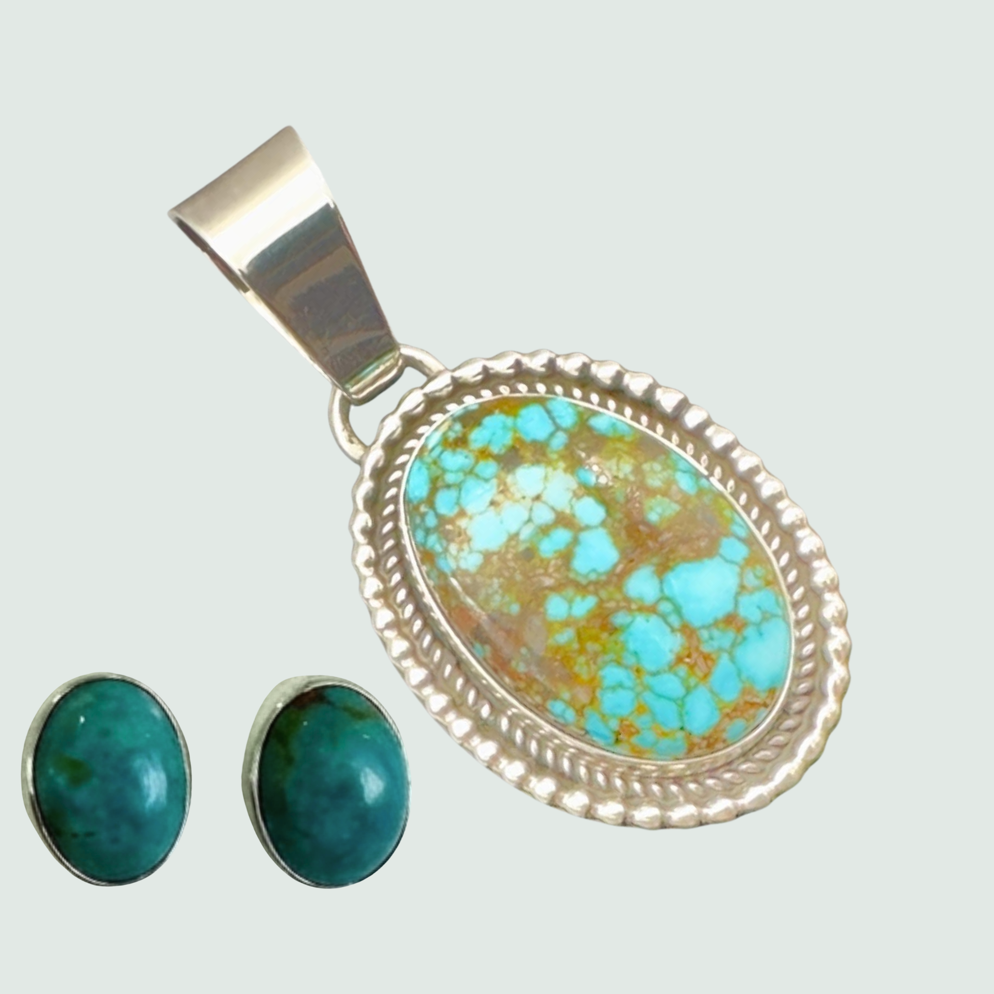Kingman Red Web turquoise pendant and oval turquoise stud earrings jewelry set in sterling silver, shown on a sage mist background