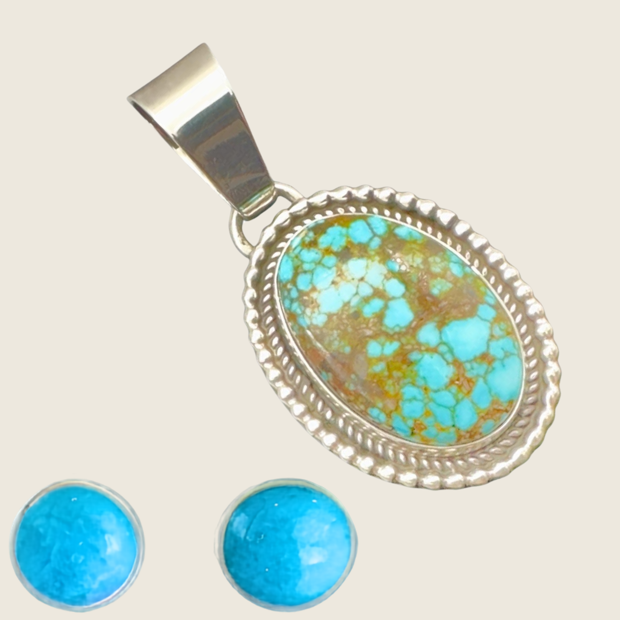 Kingman Red Web turquoise pendant and turquoise stud earrings jewelry set in sterling silver, shown on a bone linen background