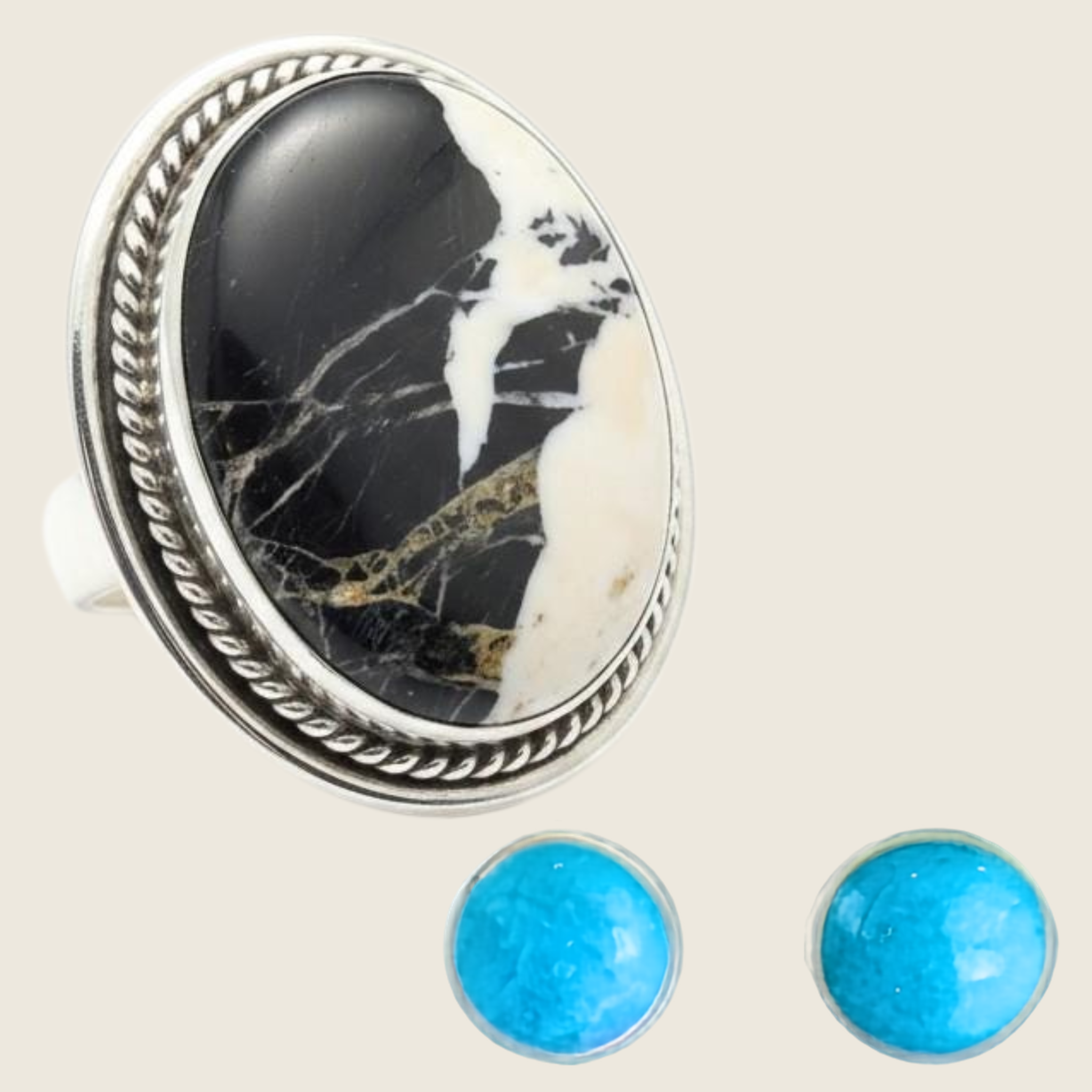 White buffalo ring and turquoise stud earrings jewelry set in sterling silver, shown on a bone linen background