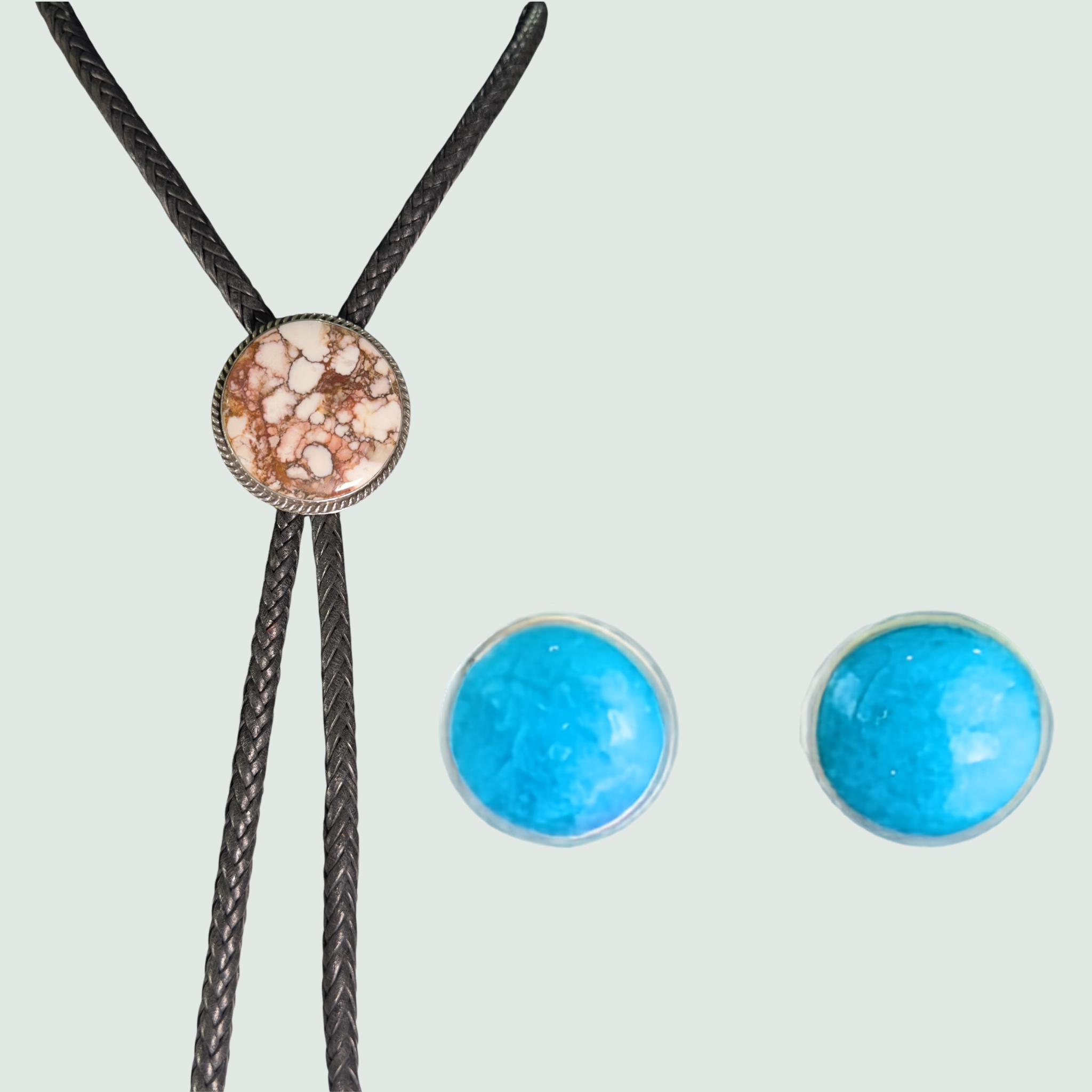 Wild horse bolo tie and turquoise stud earrings jewelry set in sterling silver, shown on a sage mist background