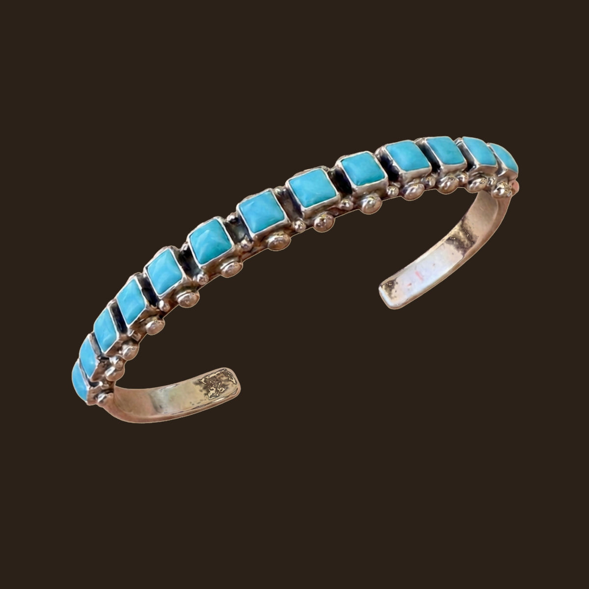 Sleeping Beauty Turquoise Row Bangle in Sterling Silver, by Don Lucas, shown on an espresso background