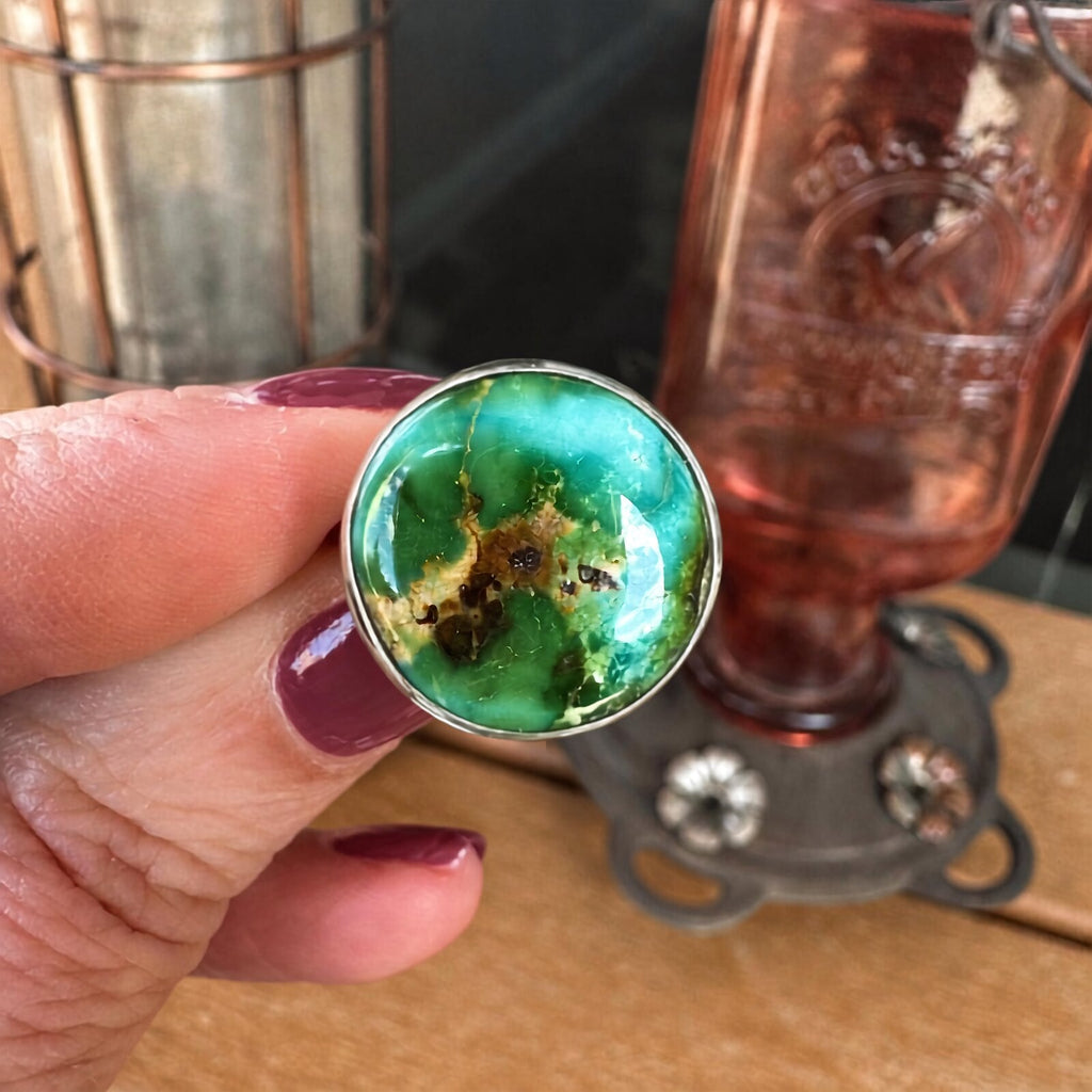 Sonoran Mountain turquoise sterling silver ring held in hand, showing the scale of the 12 carat round stone