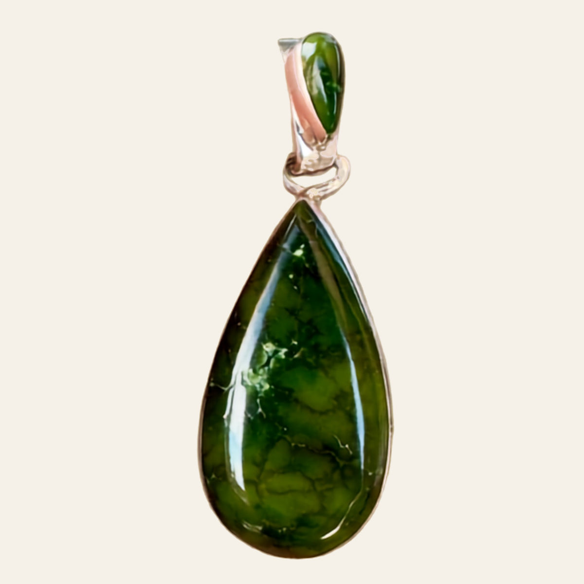 Sonoran Mountain Turquoise Teardrop Pendant in Sterling Silver, by Martinez, shown on a cream background