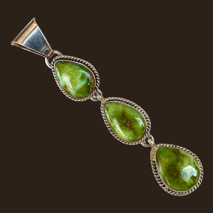 Sonoran Mountain Turquoise Triple Teardrop Pendant in Sterling Silver, by C. Wylle, shown on an espresso background