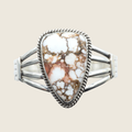 Wild horse rope edge cuff bracelet in Navajo sterling silver by P. Yazzie, shown on a bone linen background