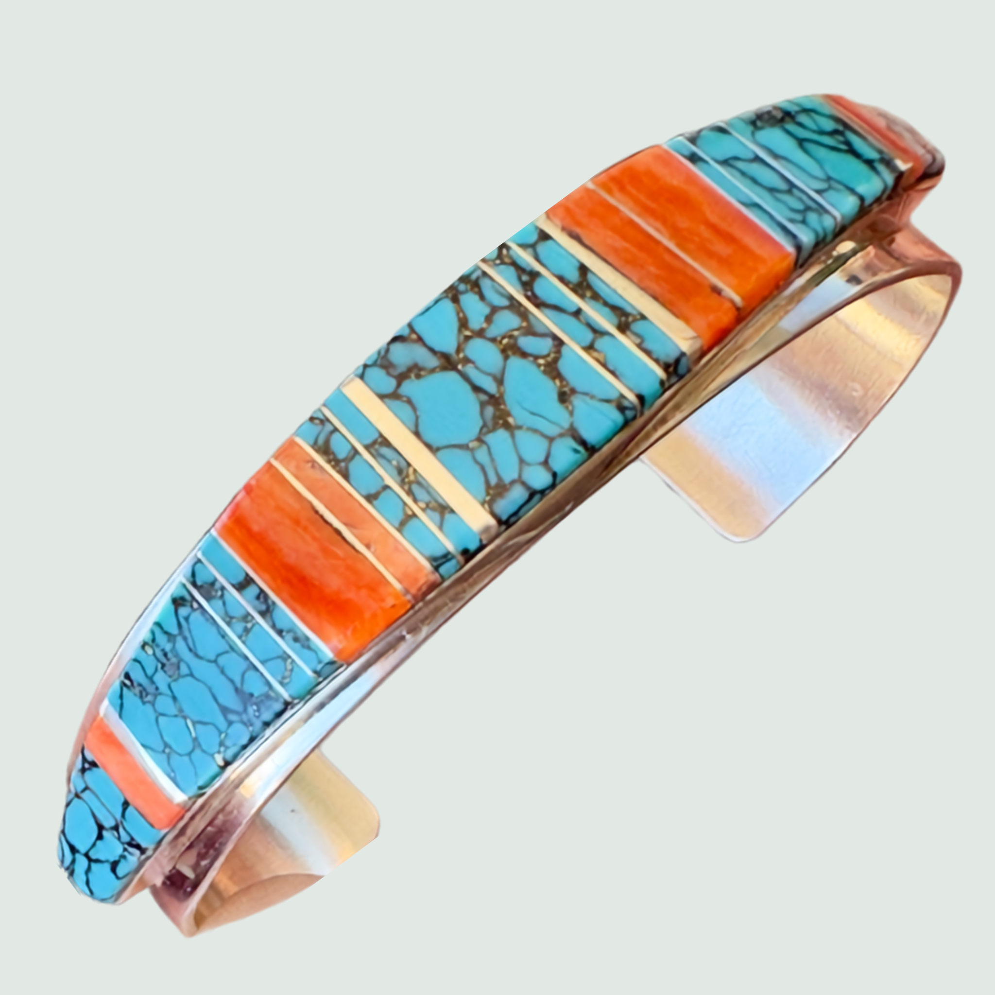 Turquoise and Spiny Oyster Channel Inlay Cuff Bracelet in Sterling Silver, shown on a sage mist background