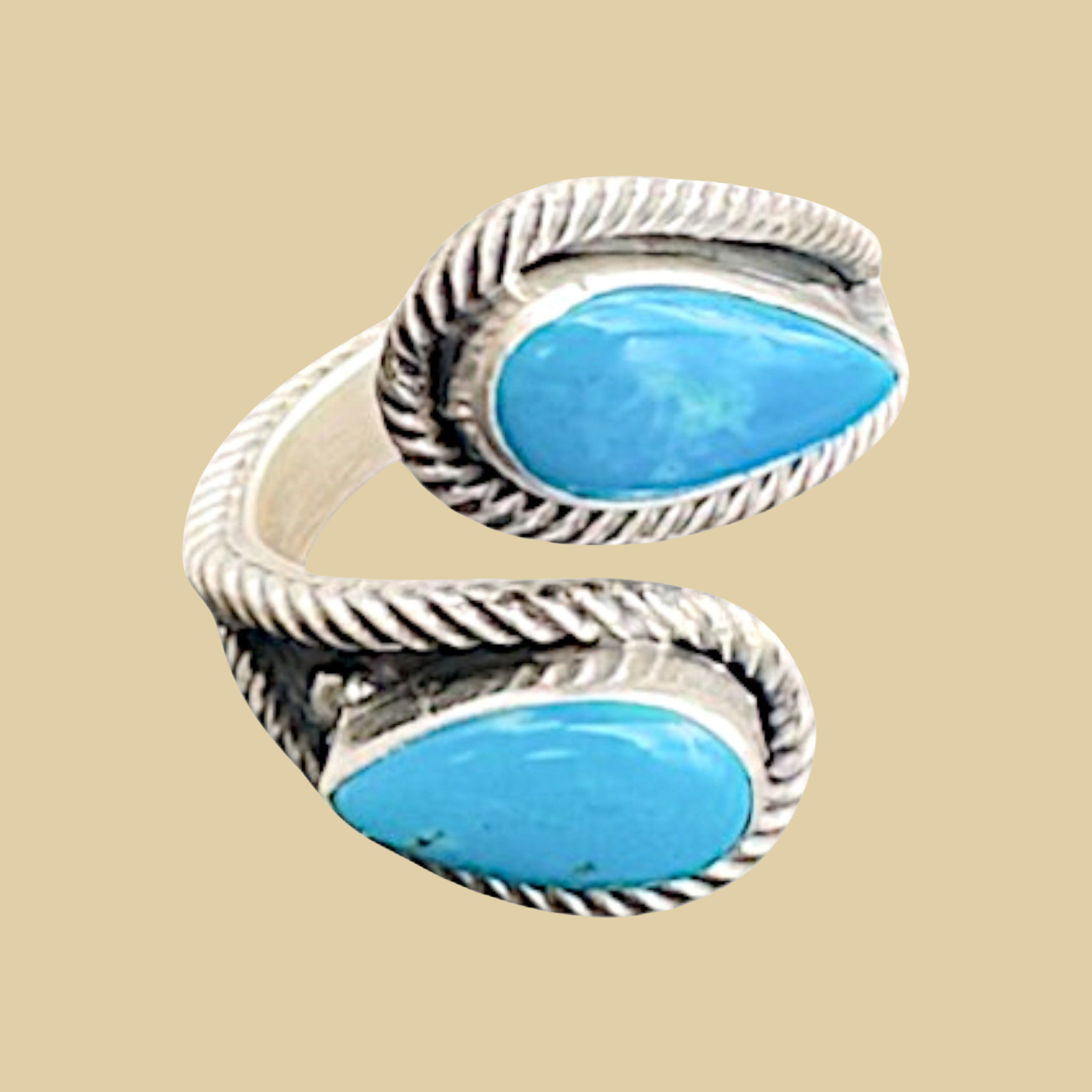 Turquoise Bypass Ring in Zuni Sterling Silver, by Kenny Lonjose, shown on a desert plaster background