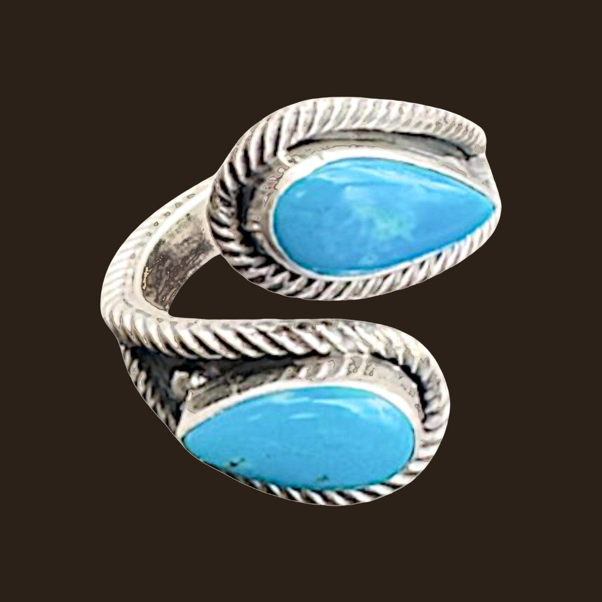 Turquoise Bypass Ring in Zuni Sterling Silver, by Kenny Lonjose, shown on an espresso background