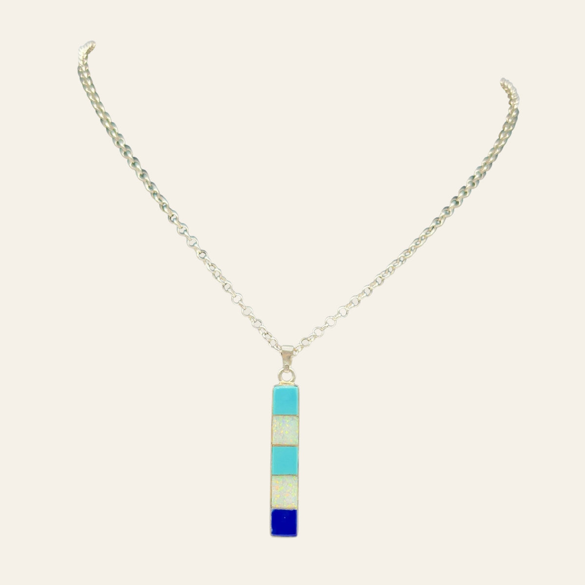Turquoise, Opal and Lapis Necklace in Sterling Silver, by Rick Tolino, shown on a cream background