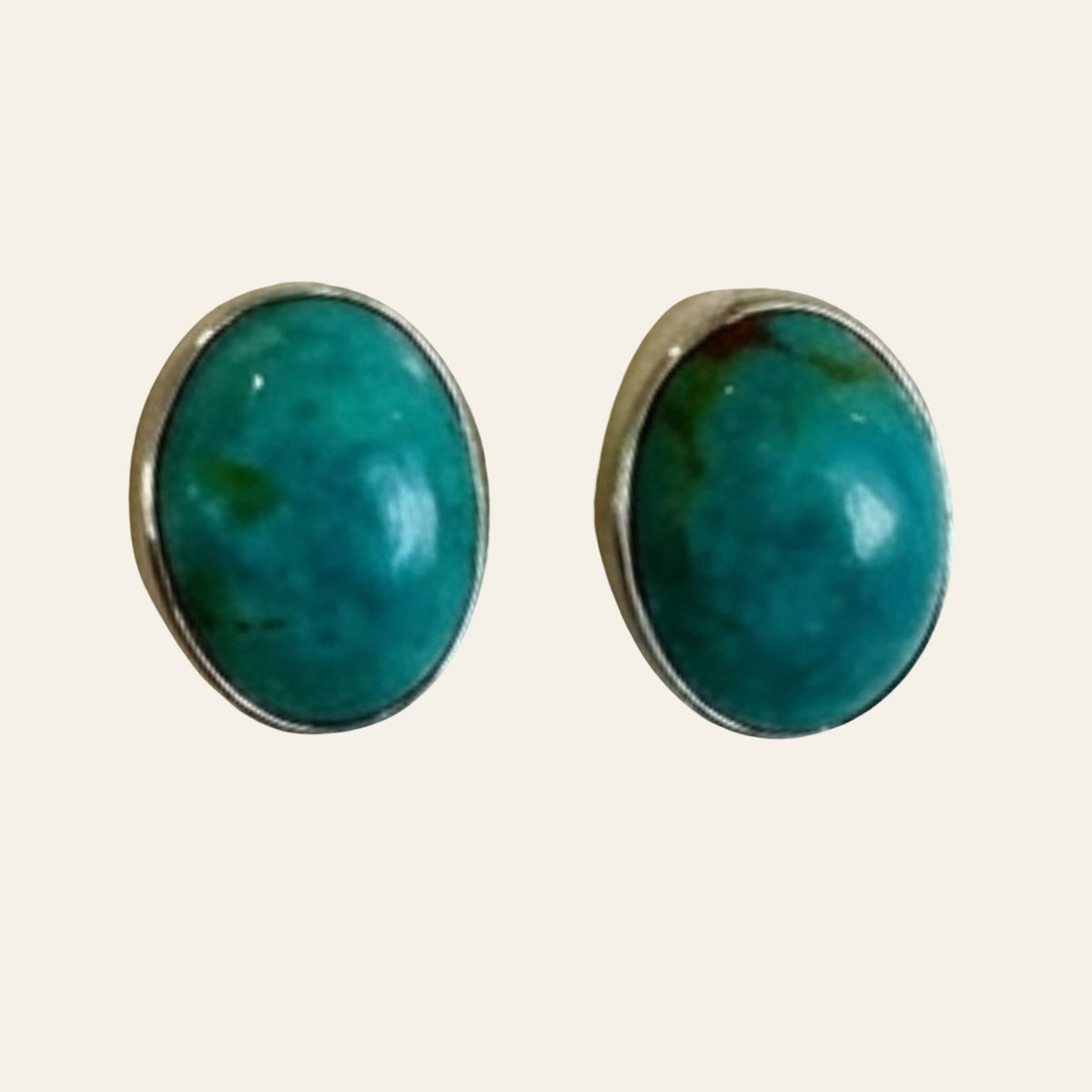 Turquoise Oval Stud Earrings in Sterling Silver, One of a Kind, shown on a cream background