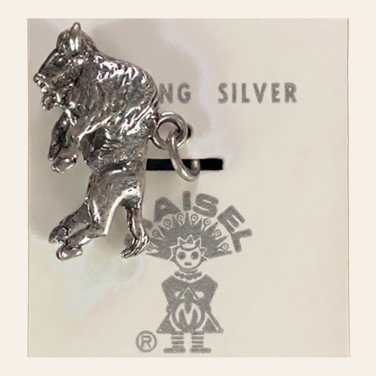 Vintage Maisel's Sterling Silver Buffalo Charm, New Old Stock, shown on a cream background
