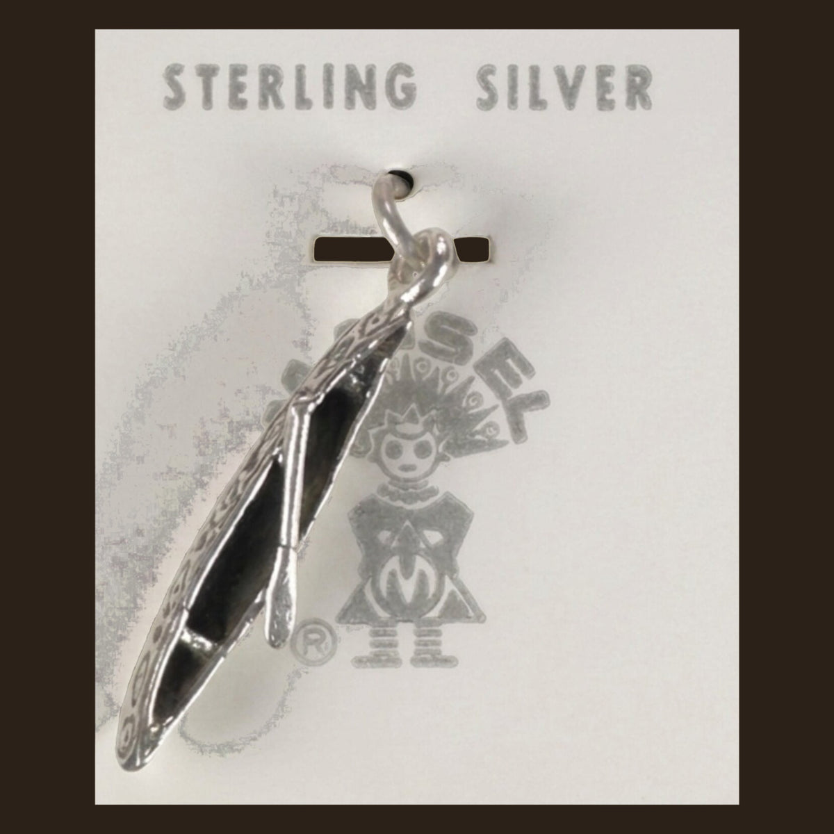 Vintage Maisel's Sterling Silver Canoe Charm, New Old Stock, shown on an espresso background