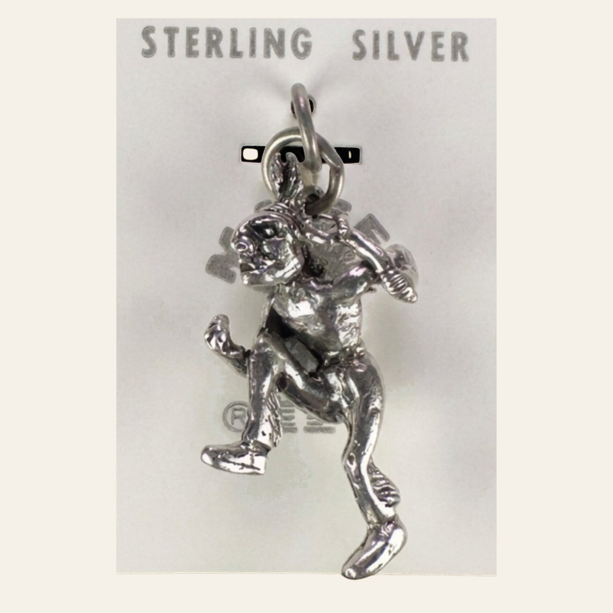 Vintage Maisel's Sterling Silver Dancer Charm, New Old Stock, shown on a cream background