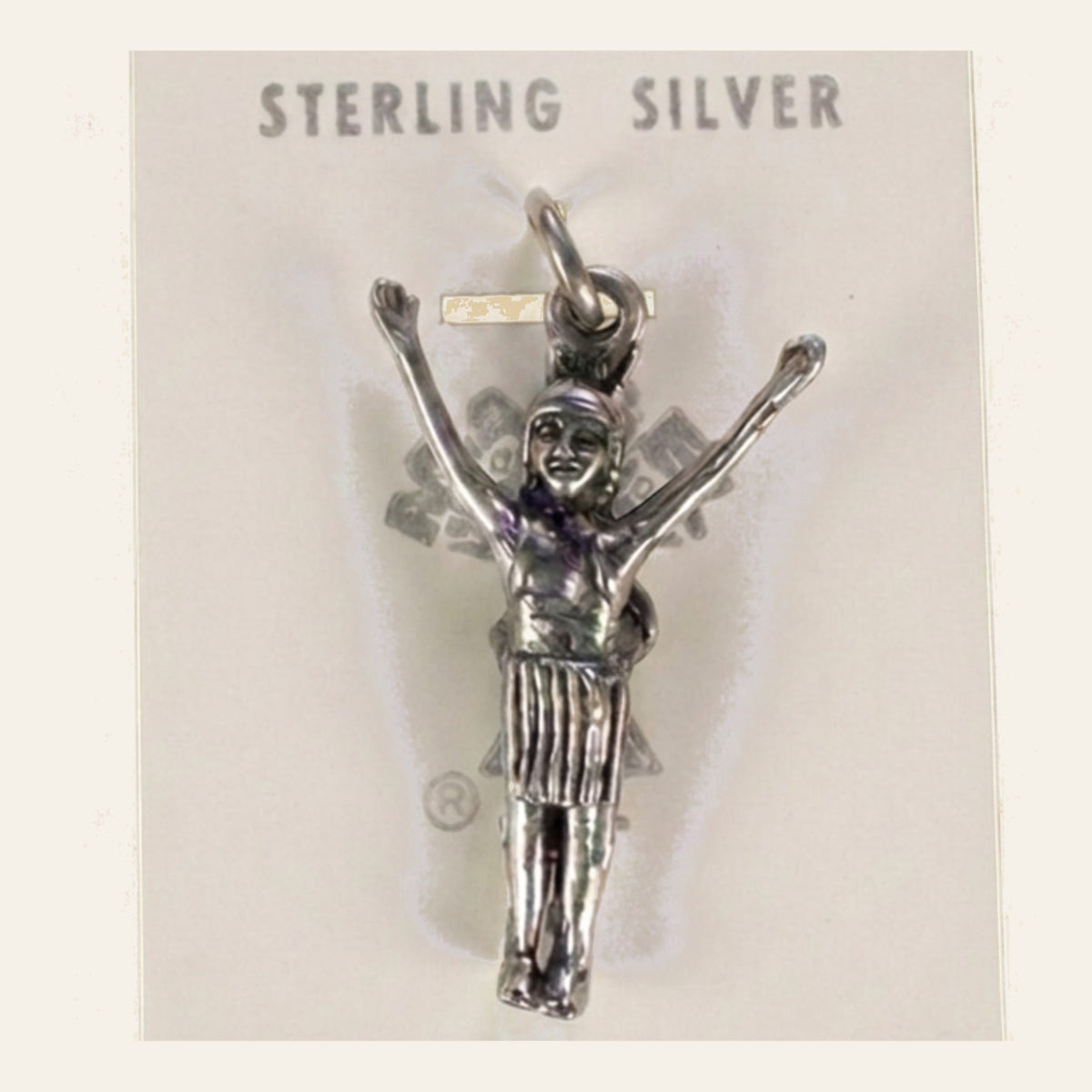 Vintage Maisel's Sterling Silver Figure with Arms Raised Charm, New Old Stock, shown on a cream background