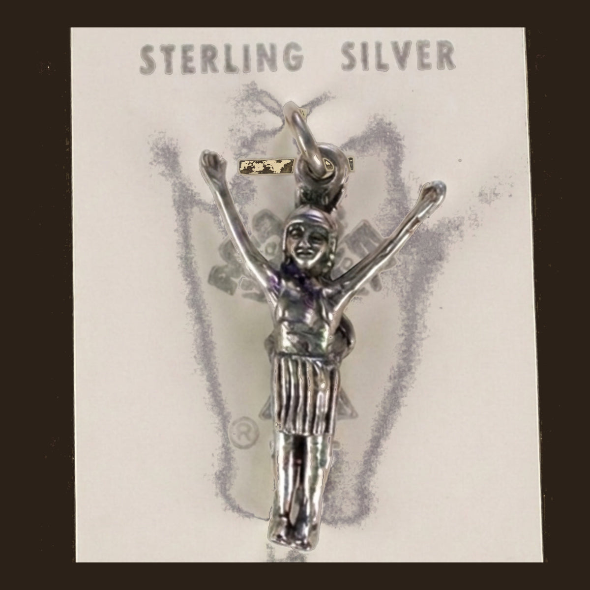 Vintage Maisel's Sterling Silver Figure with Arms Raised Charm, New Old Stock, shown on an espresso background