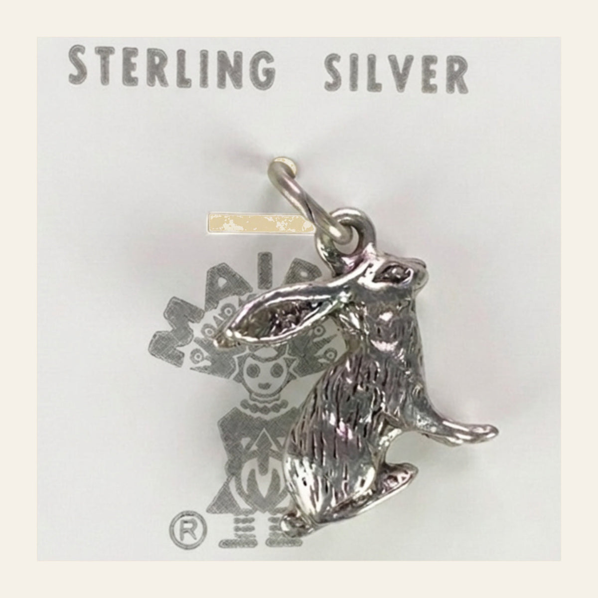 Vintage Maisel's Sterling Silver Jackrabbit Charm, New Old Stock, shown on a cream background