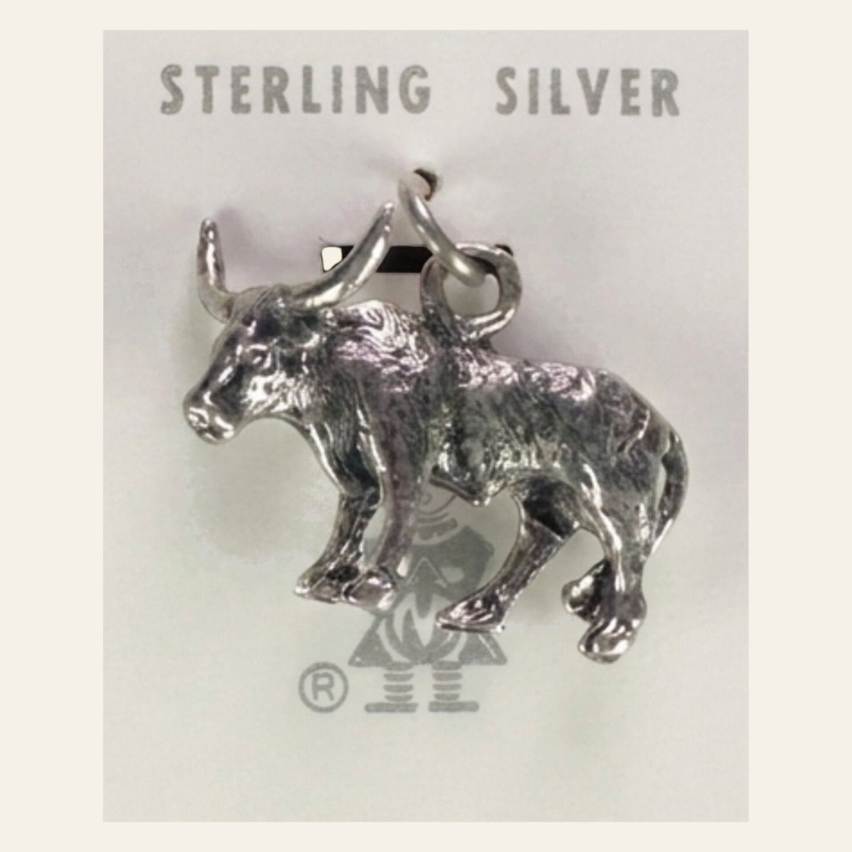 Vintage Maisel's Sterling Silver Longhorn Charm, New Old Stock, shown on a cream background
