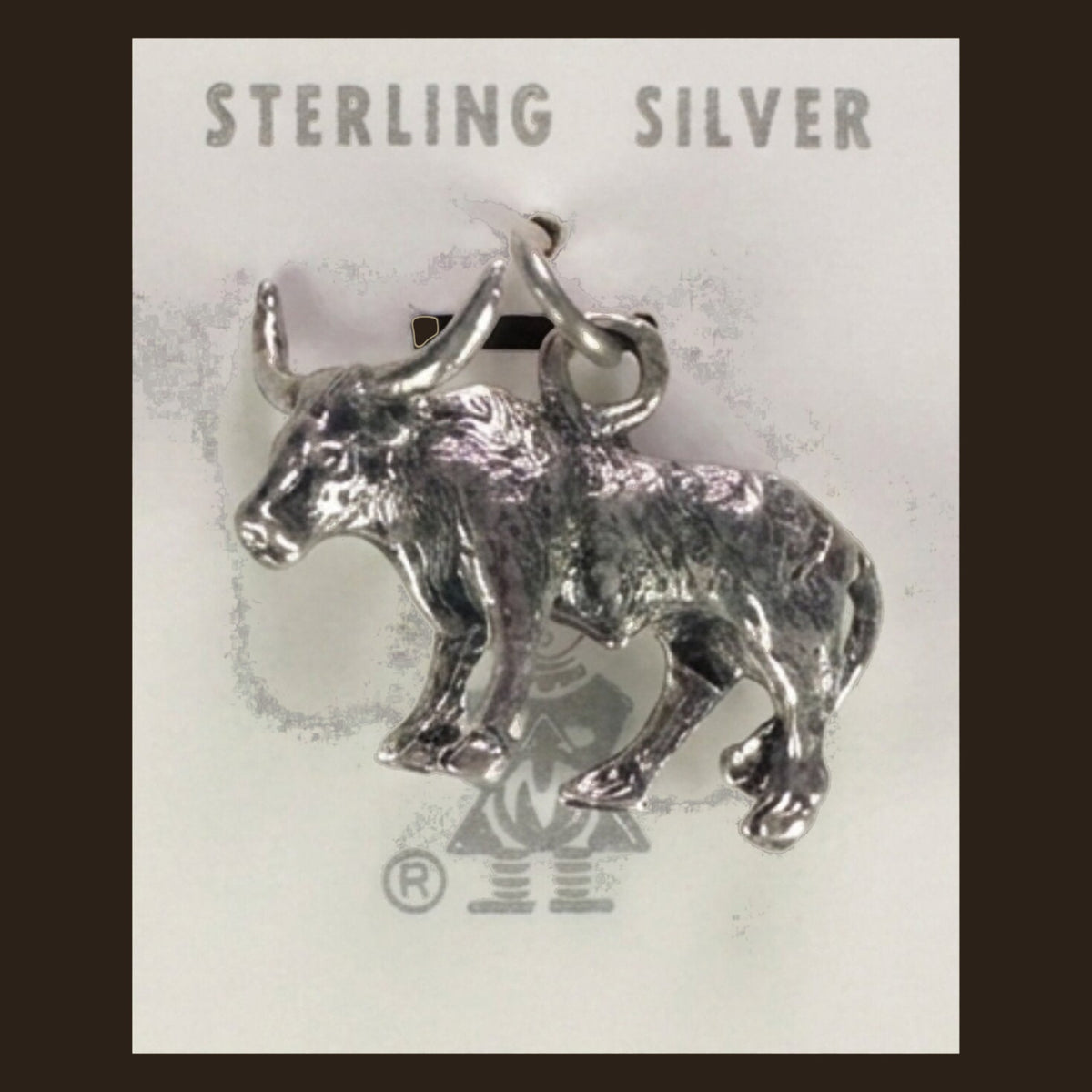 Vintage Maisel's Sterling Silver Longhorn Charm, New Old Stock, shown on an espresso background