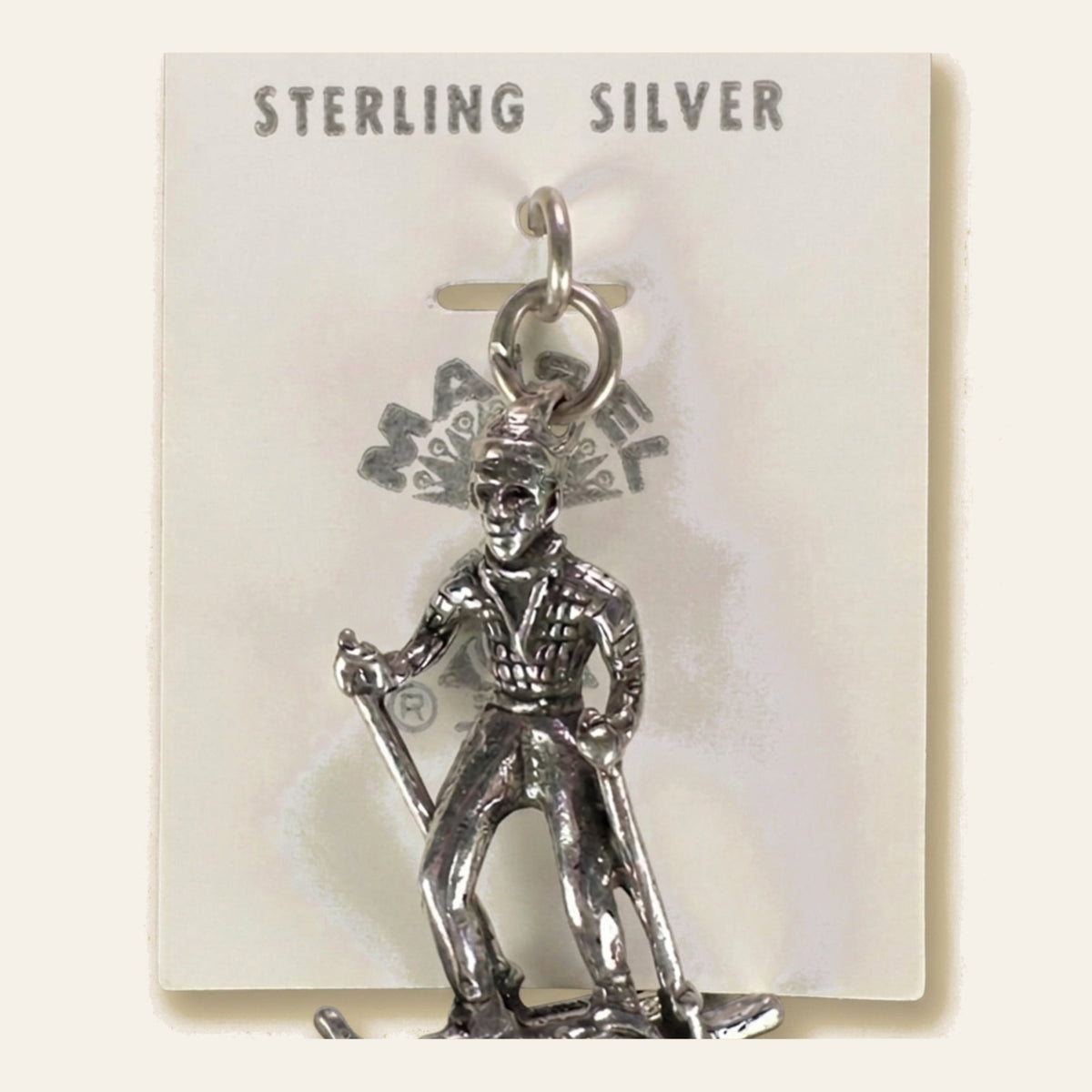 Vintage Maisel's Sterling Silver Skier Charm, New Old Stock, shown on a cream background