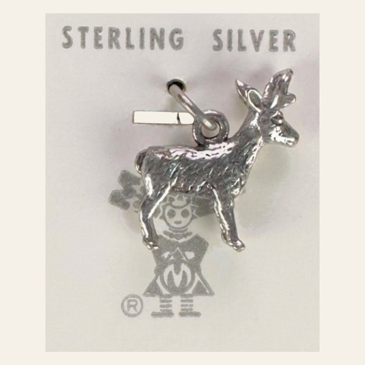 Vintage Maisel's Sterling Silver Standing Elk Charm, New Old Stock, shown on a cream background