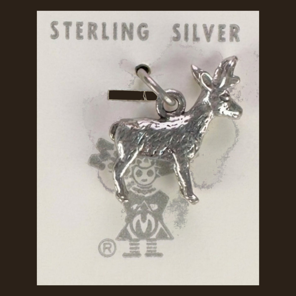 Vintage Maisel's Sterling Silver Standing Elk Charm, New Old Stock, shown on an espresso background