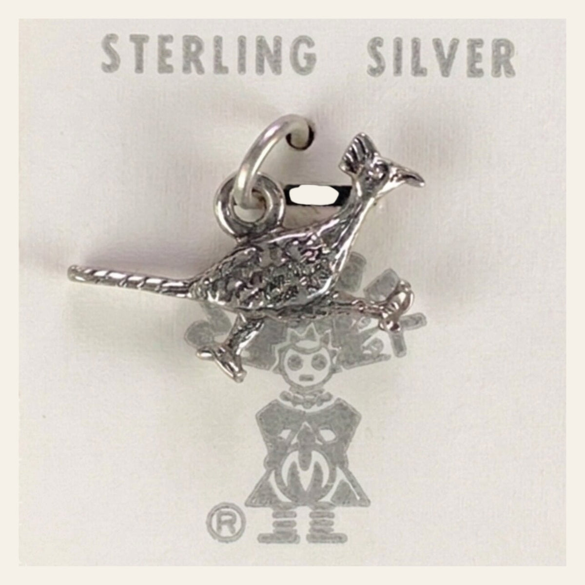 Vintage Maisel's Sterling Silver Textured Roadrunner Charm, New Old Stock, shown on a cream background