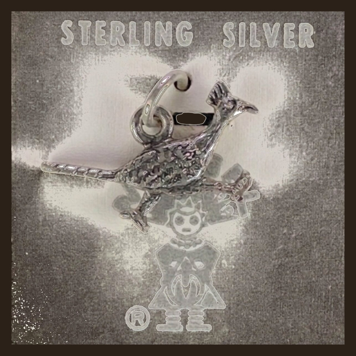 Vintage Maisel's Sterling Silver Textured Roadrunner Charm, New Old Stock, shown on an espresso background