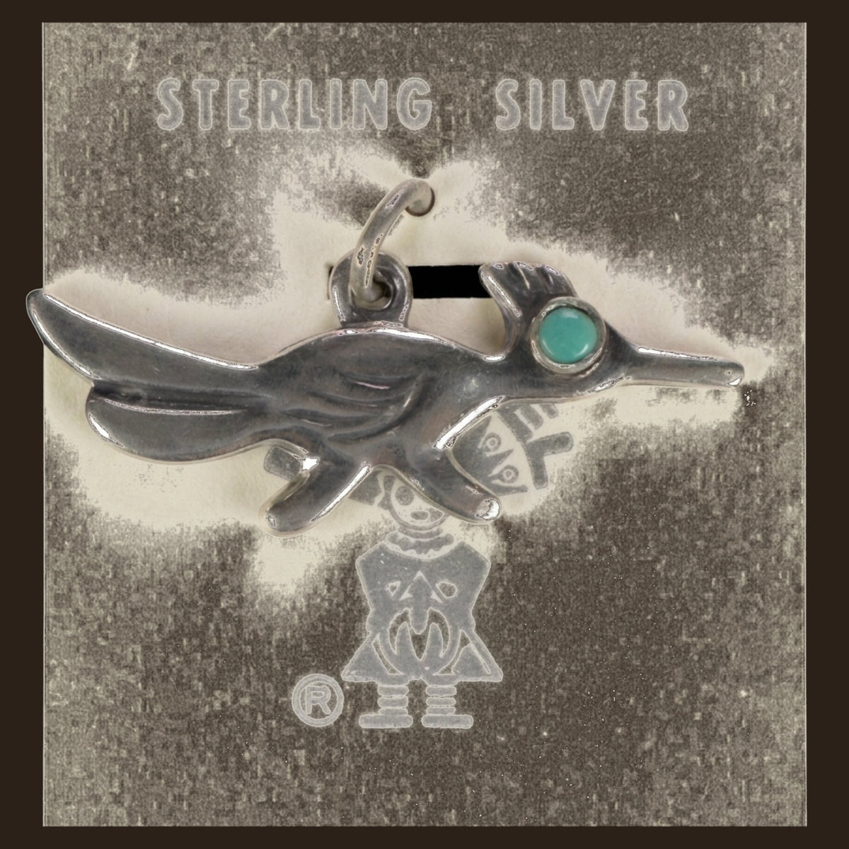 Vintage Maisel's Sterling Silver Turquoise Eye Roadrunner Charm, New Old Stock, shown on an espresso background