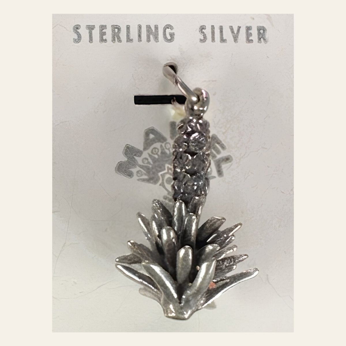 Vintage Maisel's Sterling Silver Yucca Charm, New Old Stock, shown on a cream background