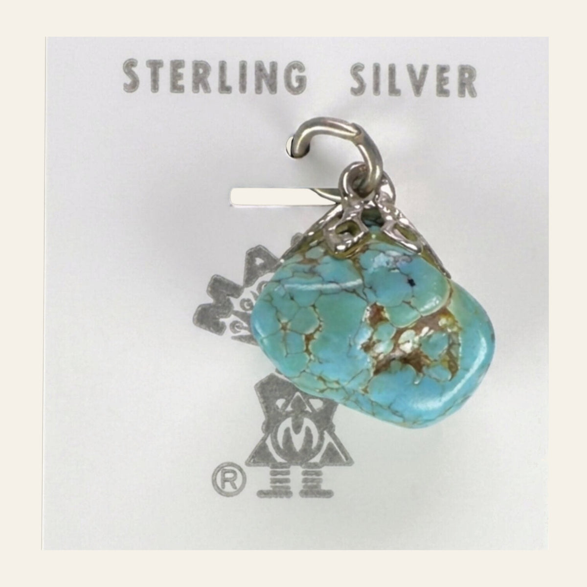 Vintage Maisel's Turquoise Nugget Sterling Silver Pendant, New Old Stock, shown on a cream background