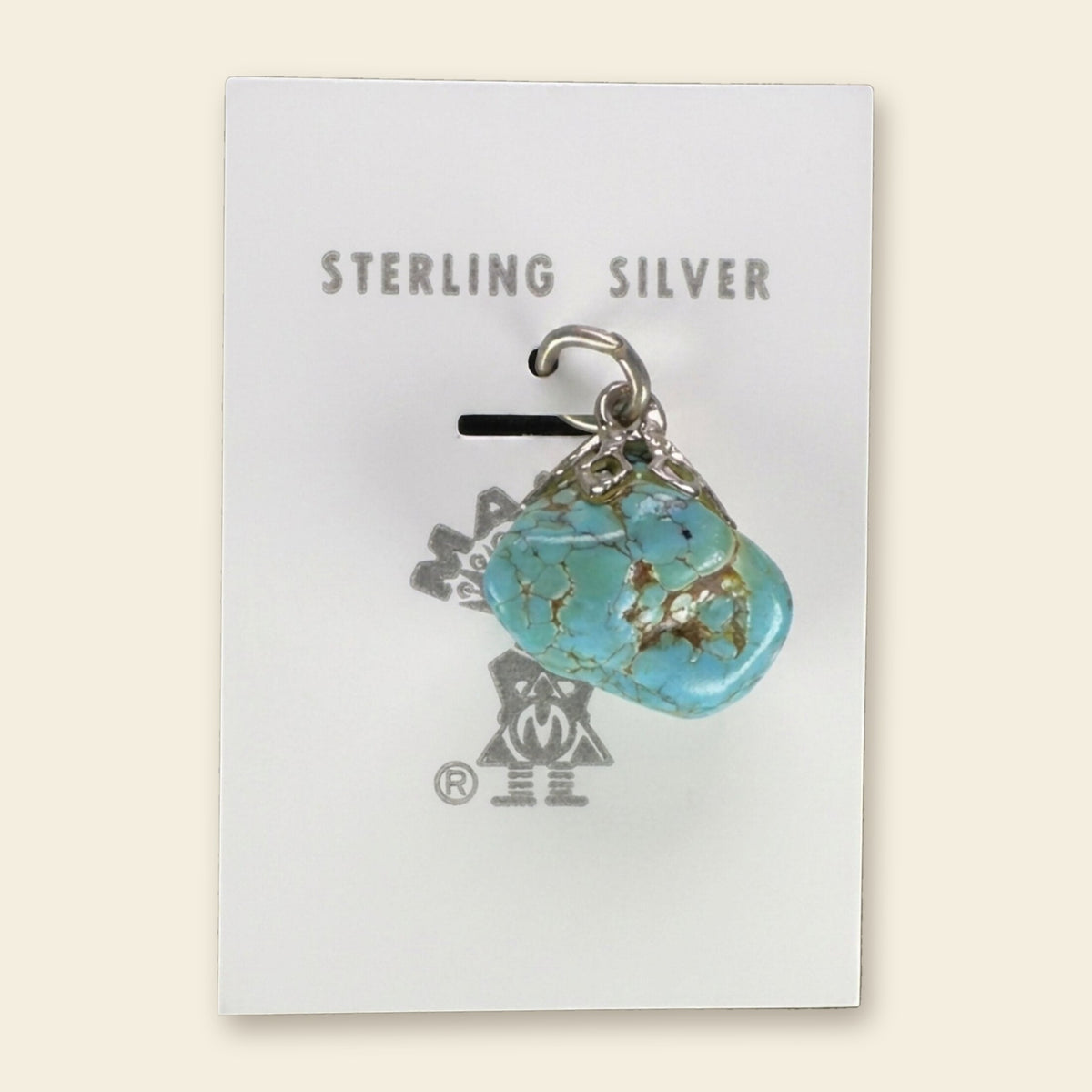 Vintage Maisel's Spiderweb Turquoise Nugget Pendant in Sterling Silver, New Old Stock, shown on an ivory background