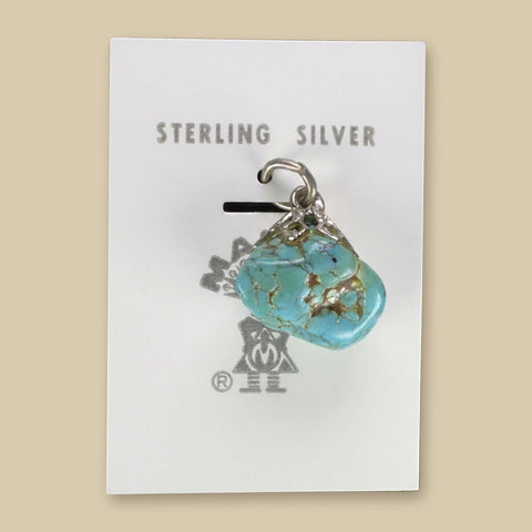 Vintage Maisel's Spiderweb Turquoise Nugget Pendant in Sterling Silver, New Old Stock, shown on a sand background