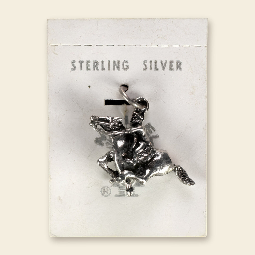 Vintage Maisel's Sterling Silver Bucking Bronco Charm, New Old Stock, shown on an ivory background
