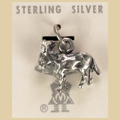 Vintage Maisel's Sterling Silver Burro Charm, New Old Stock, shown on a desert plaster background