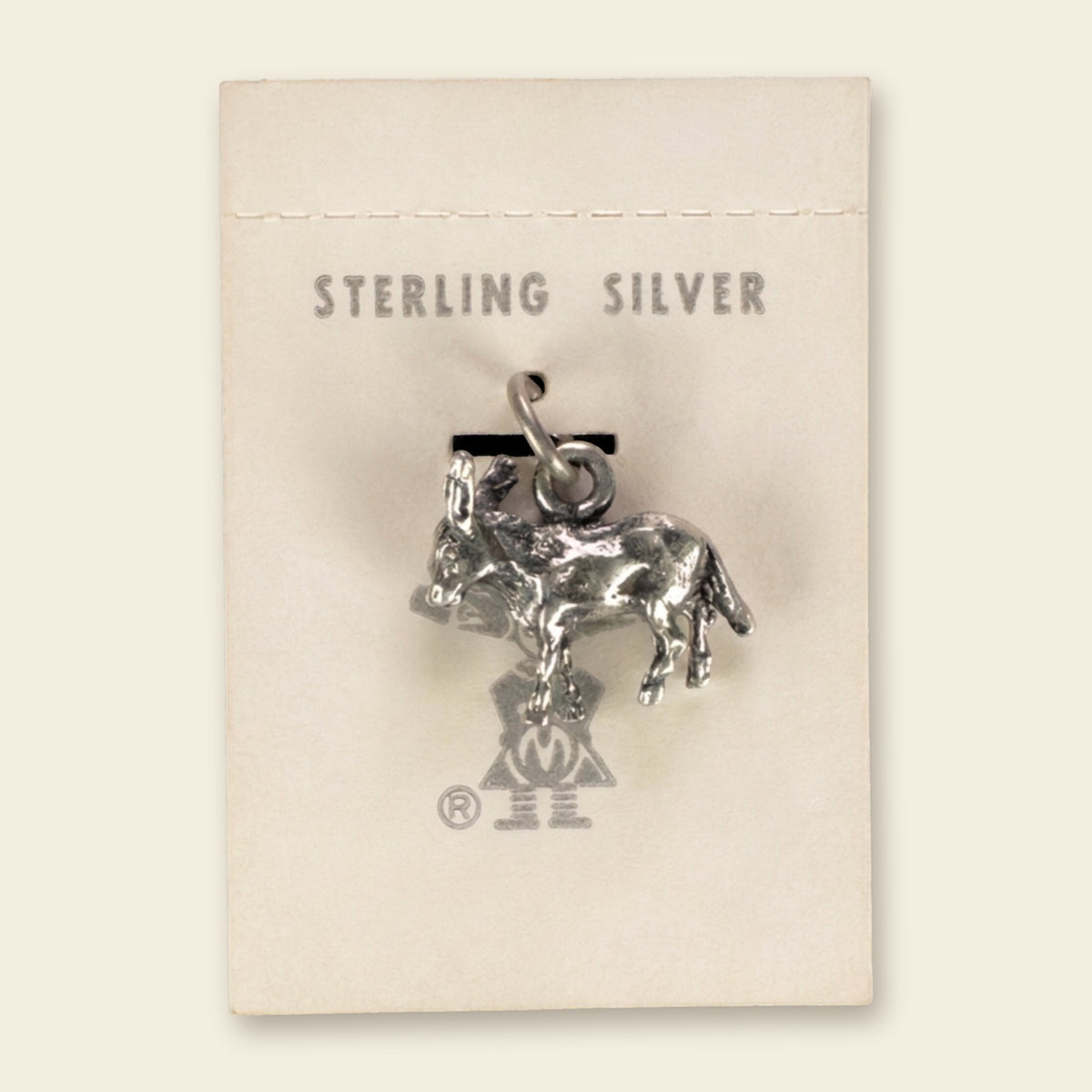 Vintage Maisel's Sterling Silver Burro Charm, New Old Stock, shown on an ivory background