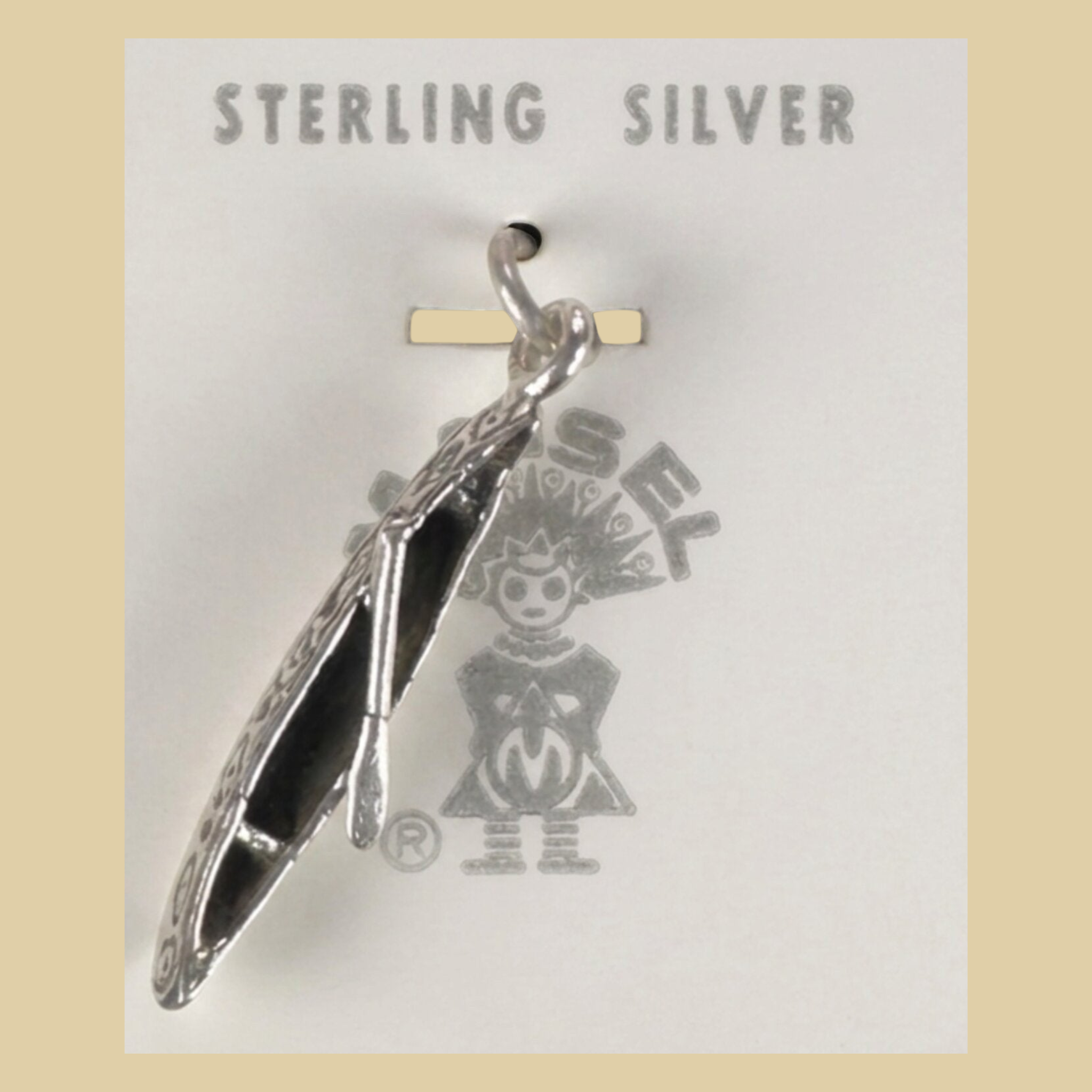 Vintage Maisel's Sterling Silver Canoe Charm, New Old Stock, shown on a desert plaster background