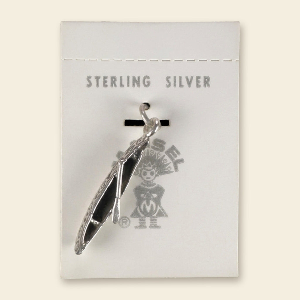 Vintage Maisel's Sterling Silver Canoe Charm, New Old Stock, shown on an ivory background
