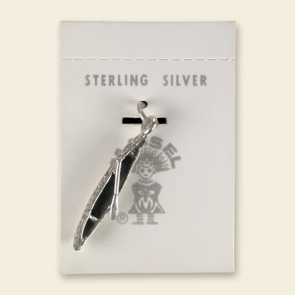 Vintage Maisel's Sterling Silver Canoe Charm, New Old Stock, shown on an ivory background