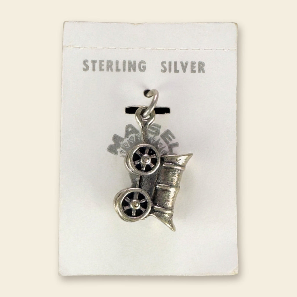 Vintage Maisel's Sterling Silver Covered Wagon Charm, New Old Stock, shown on an ivory background