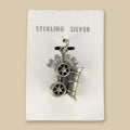 Vintage Maisel's Sterling Silver Covered Wagon Charm, New Old Stock, shown on a sand background