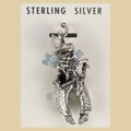 Vintage Maisel's Sterling Silver Cowboy Charm, New Old Stock, shown on a desert plaster background